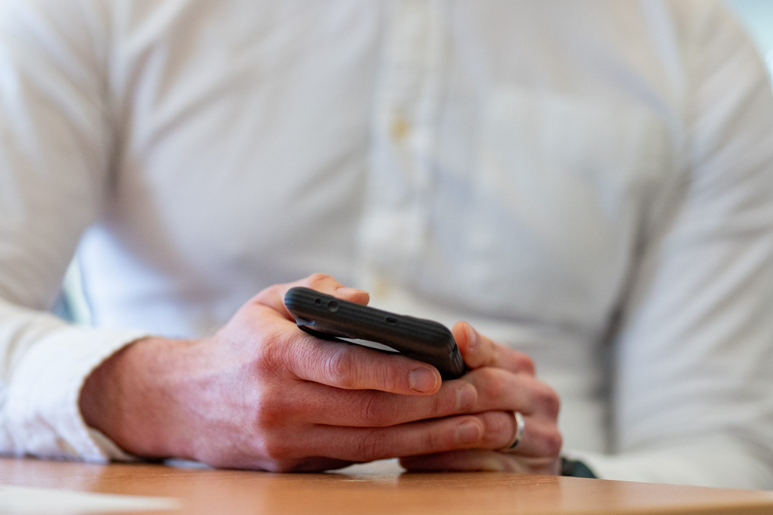 Norwich Research Park. Owned image of man holding mobile phone